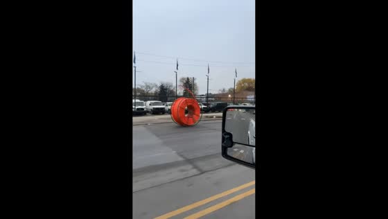 Electrical conduit rolls in the middle of the road in Chicago, Illinois, USA