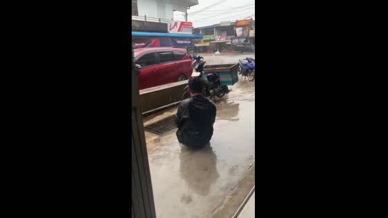 Friend slips and falls while running in rain, West Kalimantan, Indonesia