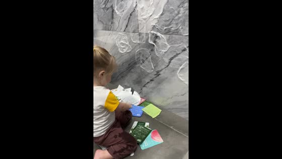 Child sticks face masks to wall tiles in Yalta