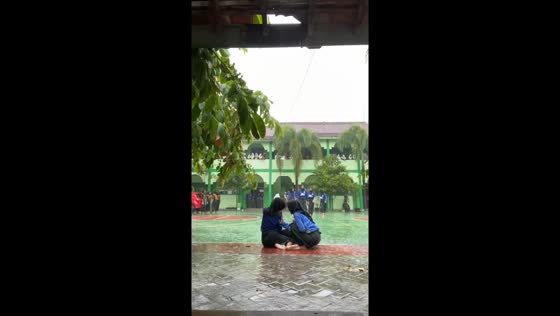 Rainy day mishap: girl hit by football while seated in the rain