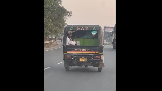   Person and dog share a moment in auto-rickshaw in Cuttack, Odisha