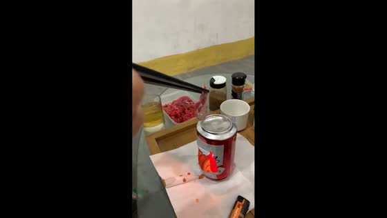 Man cooks meat using candle heater in Fujian, China