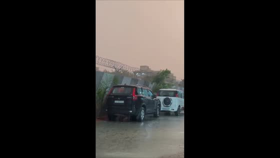 Woman slips while filming in the rain in Kalol, India