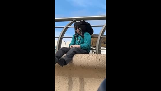 Boy shields himself from seagulls in Blackpool, England, UK