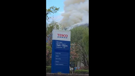 Massive fire sends thick smoke into sky near petrol station in Uddingston, Scotland, UK