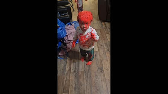 Toddler twins get covered in red paint in Houston, Texas, USA