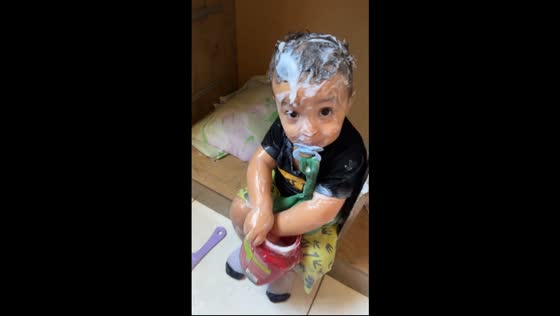 Little boy covers himself in hair cream while playing in Capixaba, Acre, Brazil
