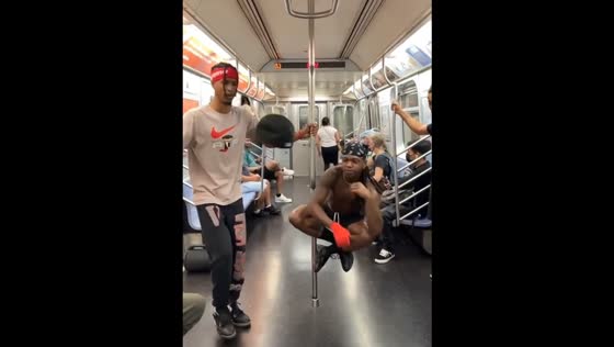 Dancers perform litefeet hat tricks inside subway train in New York, USA