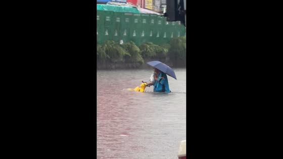 Motorcyclist rides through flooded road in Liaoning, China