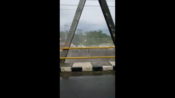 Flooded road leaves cars stranded in Magelang, Java, Indonesia