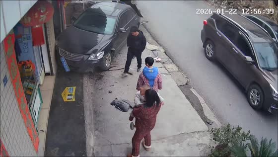 Black car crashes into storefront and driver checks scene in Guizhou, China