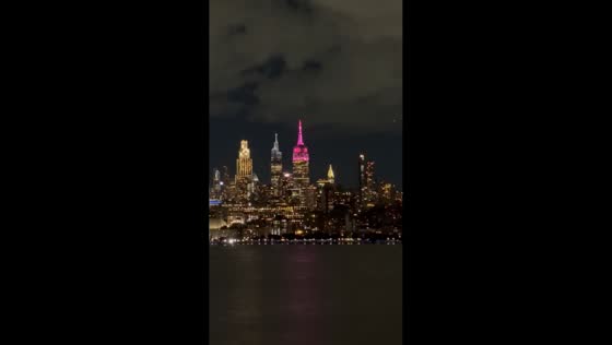 Empire State Building shimmers in pink during Dolly Parton tribute, seen from New Jersey, USA