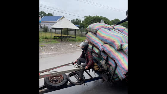 Vehicle tipped over onto its side due to heavy charcoal load in Battambang