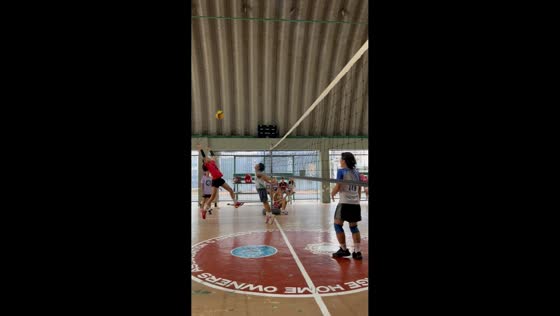 Volleyball player leans into net during funny rally in Marikina, Philippines