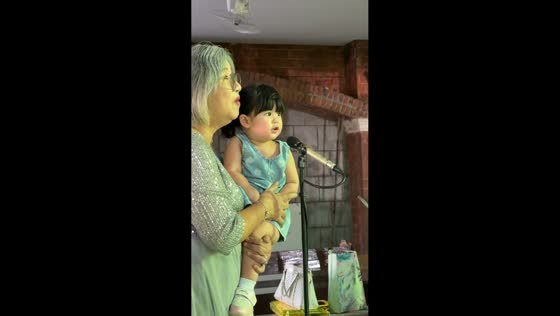 Little girl charms crowd while singing with elderly woman in San Pablo, Philippines