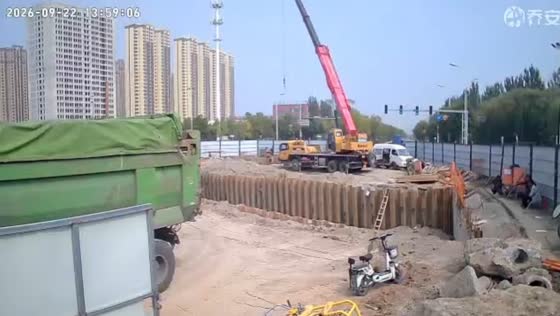 Truck tips toward excavation after striking fence at construction site in Shanxi, China