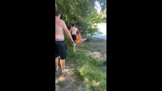People submerge burning dirt bike in river in Vodny, Krasnodar Krai, Russia