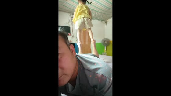 Father and daughter share playful balance moment in Anhui, China