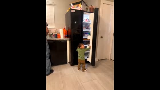 Boy offers a drink to his grandpa in Texas, USA