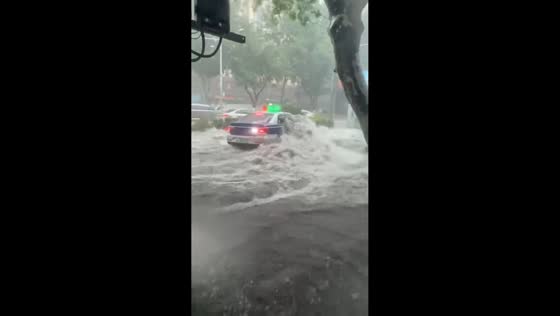 Vehicles battle floodwaters during intense rain in Jinan, China