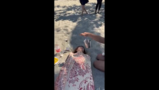 Woman keeps sleeping despite noise on beach in Balatan, Camarines Sur, Philippines