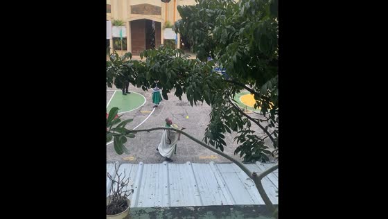 Priest plays badminton in Manila