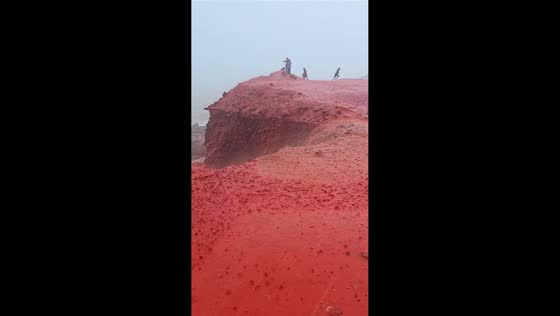 Red rainwater flows down cliffs on Hormuz Island, Iran