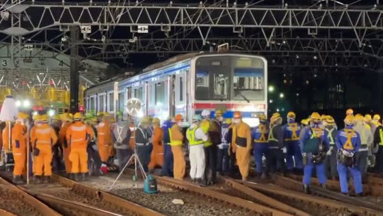 Derailed train slips during rerailing at crossing in Tokyo, Japan