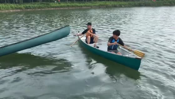 Canoe riders use unusual maneuver to pass over another boat in Shanghai, China