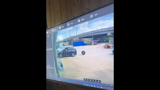 Loose tire rolls into parked car in unexpected parking lot mishap in Jiangsu, China