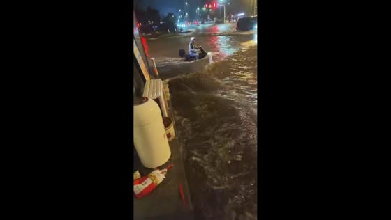 Scooter rider navigates severe nighttime flooding in Shanxi, China