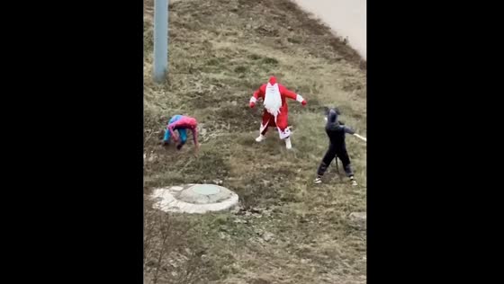 People in costumes of Ratatouille, Santa, and Spider-Man fight beside road in Russia