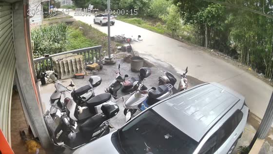 Motorcycle loses control and crashes into canal on rural road in Guangxi, China