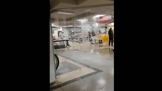 Lisbon floods: water flowing from the roof floods the mall