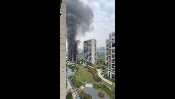 Fire sends dense smoke over high-rise residential building in Hangzhou, China