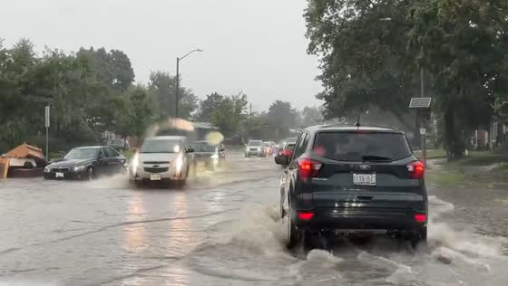 Torrential rain triggers flash flood chaos: cars navigate flooded Maitland Ave in Ottawa