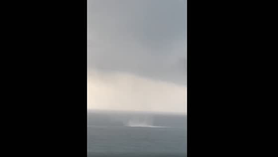 A waterspout is forming in the Gulf at Panama City Beach.