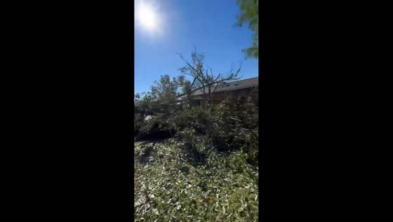 Family surveys hurricane damage to their home in Santa Rosa, USA