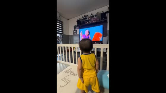 Toddler dances and freezes with performer on TV in Cainta, Rizal, Philippines