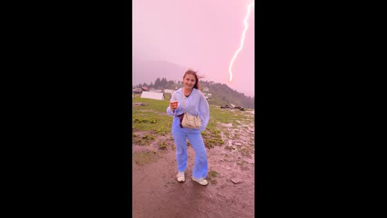 Sudden lightning strike startles woman during video shoot in Gomismta, Georgia
