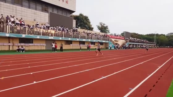 Runner trips and falls while waving to the crowd during a campus sports event in Jiangsu, China