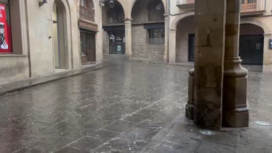Heavy hail pounds historic square in Solsona, Catalonia, Spain