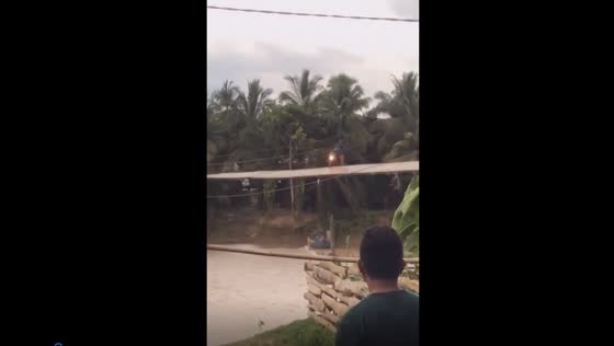 Terrifying moment: motorbike plunges into water as floating bridge swings wildly