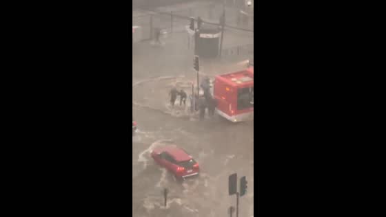 Severe flooding submerges vehicles at an intersection during a storm in Santiago, Chile