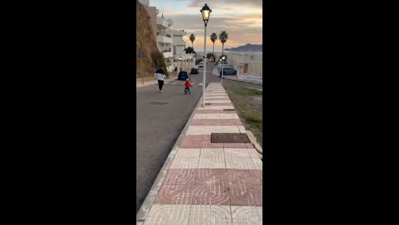 Little boy falls from bike while riding downhill in Carboneras, Spain