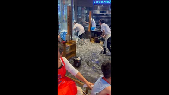 Floodwaters rush through restaurant during torrential rain in Chongqing, China