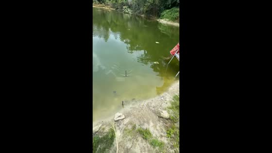 Fisher reels in unexpected object from water in Guangxi, China