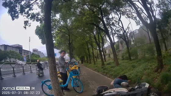 Scooter rider falls while avoiding pedestrian and man beside bicycle in Shanghai, China