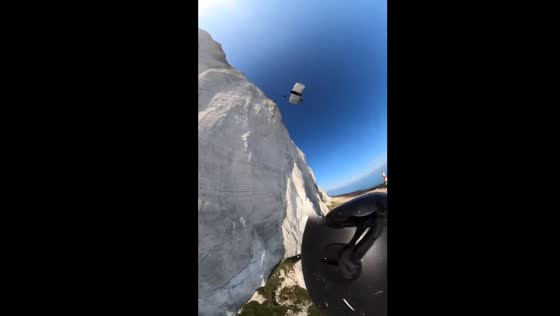 Basejumper's helmet ripped off during 350ft cliff jump in Eastbourne, captured on GoPro