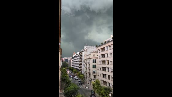 Unusual dark sky and lightning signal approaching storm in Alcoy, Spain